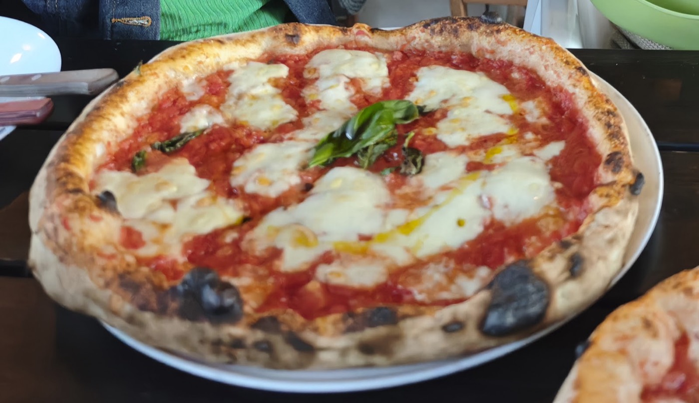 Neapolitan pizza with melted mozzarella and tomato sauce