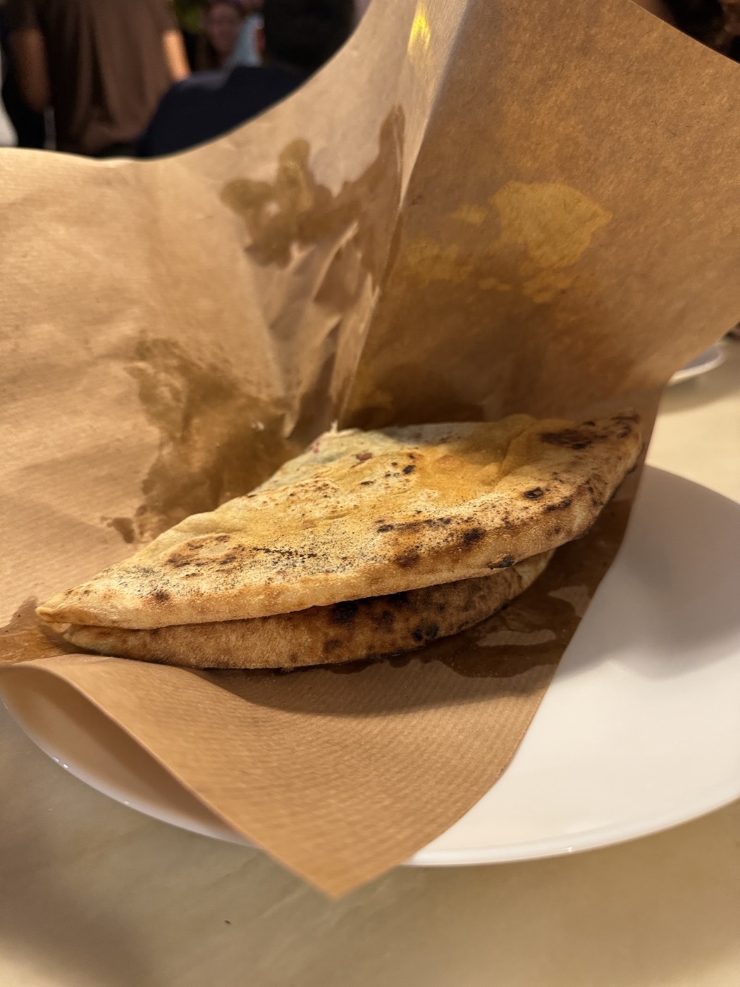 Saltimbocca pizza dough sandwich wrapped in paper